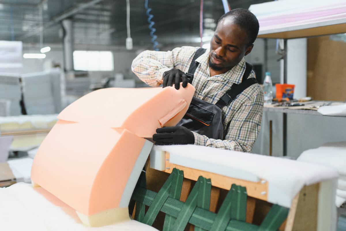 Furniture maker assembling sofa in upholstery workshop at Janovic near New York City, New York (NY)